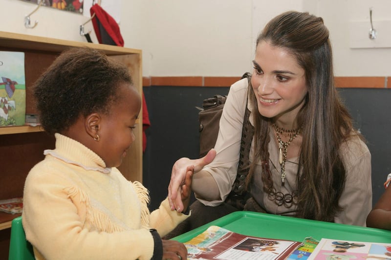 CAPE TOWN, SOUTH AFRICA - APRIL 03:  In this photo released by the Jordanian Royal Palace, Her Majesty Queen Rania of Jordan, a member of the UNICEF Global Leadership Initiative for Children, talks to a child during her visit to the Vukile Tshwete Enrichment Center in the city of Cape Town, South Africa April 03, 2006. (Photo by Jordanian Royal Court via Getty Images) 
