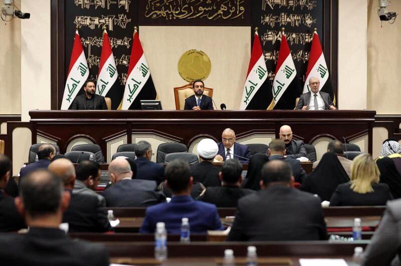 Iraqi Prime Minister Adel Abdul-Mahdi (centre, down) and Iraqi parliament speaker Mohamed al-Halbosi (centre, up) attending an Iraqi parliament session in Baghdad. Iraqi parliamentarians voted on a resolution to remove the US troops and cancel the security agreement between Iraq and US after the killing of Qassem Suleimani.  EPA