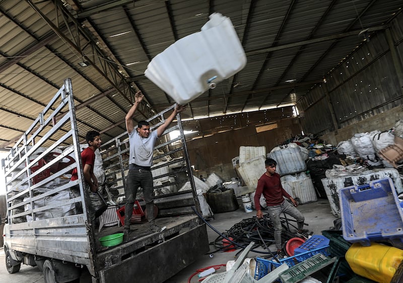 Palestinian workers sort plastic waste at a factory where it gets transformed into agricultural water hoses at a plastic recycling factory in the northern Gaza Strip.  EPA 