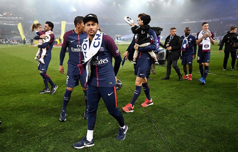 Paris Saint-Germain's Brazilian forward Neymar walks on the pitch as he celebrates after winning the French L1 title at the end of the French L1 football match Paris Saint-Germain (PSG) vs Rennes on May 12, 2018 at the Parc des Princes stadium in Paris. / AFP / FRANCK FIFE
