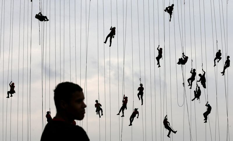 People climb after jumping off a bridge, which has a height of 30 meters, in Hortolandia, Brazil. Paulo Whitaker / Reuters