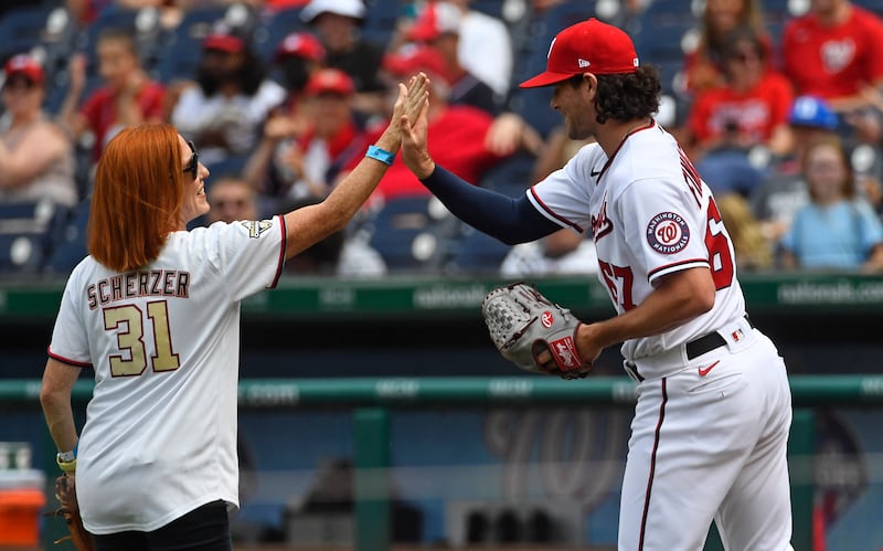 Ms Psaki gets a high-five from Washington Nationals relief pitcher Kyle Finnegan. Photo: USA TODAY Sports