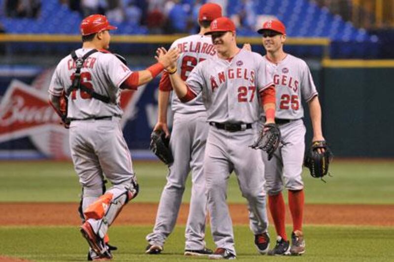 Outfielder Mike Trout, No 27, of the Angels, celebrates their 6-5 win against the Rays with catcher Hank Conger, No 16, late on Tuesday. Al Messerschmidt / Getty Images / AFP