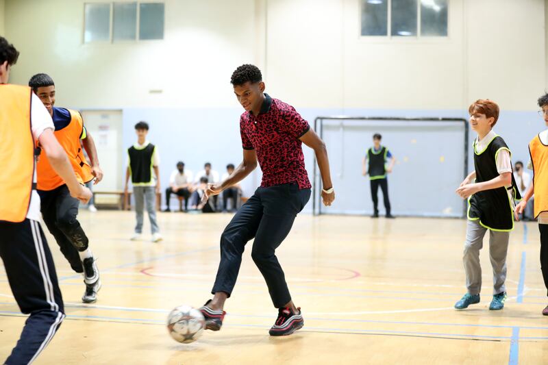 Yahya Al Ghassani plays football with pupils at Dubai Carmel School, Al Nahda, Dubai. 