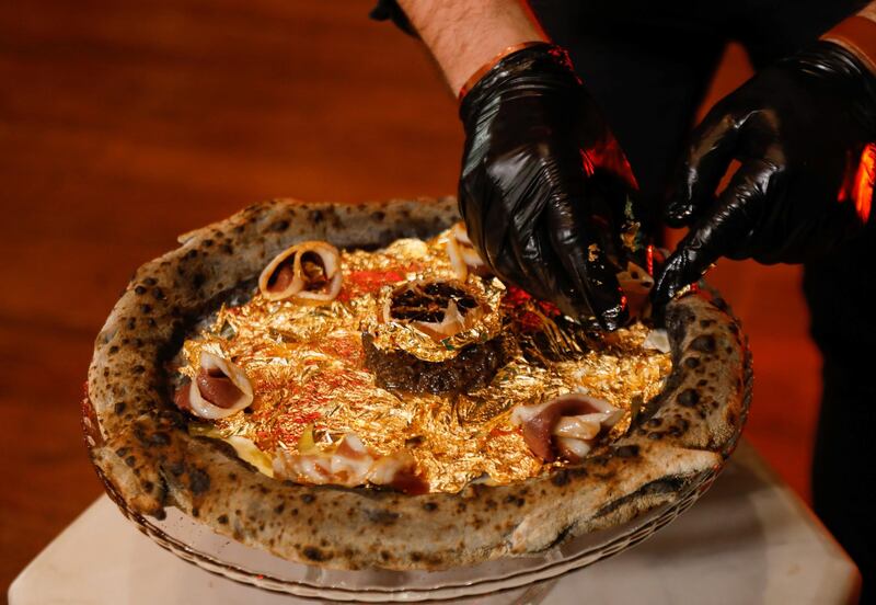 Gold leaf features prominently on the luxury pizza crafted by Ahmed Hergal at his L'antica Pizzeria DaPietro restaurant, in Tunis. Reuters