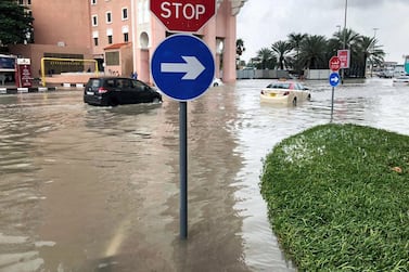 Water surrounds the Movenpick Ibn Battuta Gate Hotel after heavy overnight rain. Several cars, including an RTA taxi, were waiting for pick-up trucks after breaking down. James O’Hara / The National