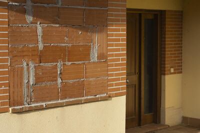 Bricks seal a window in an unfinished house in a semi-abandoned residential development in Bernuy de Porreros, near Segovia, Spain, on Monday, Oct. 15, 2018. The volume of residential mortgages sold in Spain peaked in late 2005 before hitting a low in 2013. Photographer: Angel Navarrete/Bloomberg