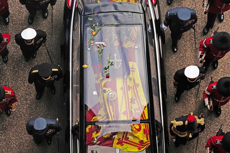 Flowers are seen on the hearse as it arrives at Windsor Castle. AP