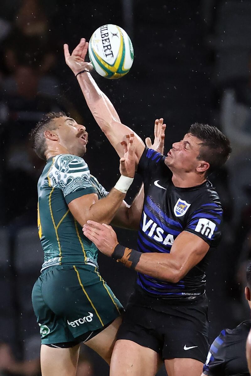 Argentina try-scorer Bautista Delguy and Australia's Nic White compete for the ball. AFP