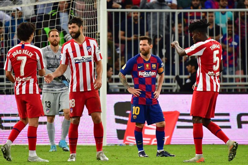 A dejected Lionel Messi, second right, after Barcelona's Spanish Super Cup defeat to Atletico Madrid at the King Abdullah Sport City in Jeddah. AFP