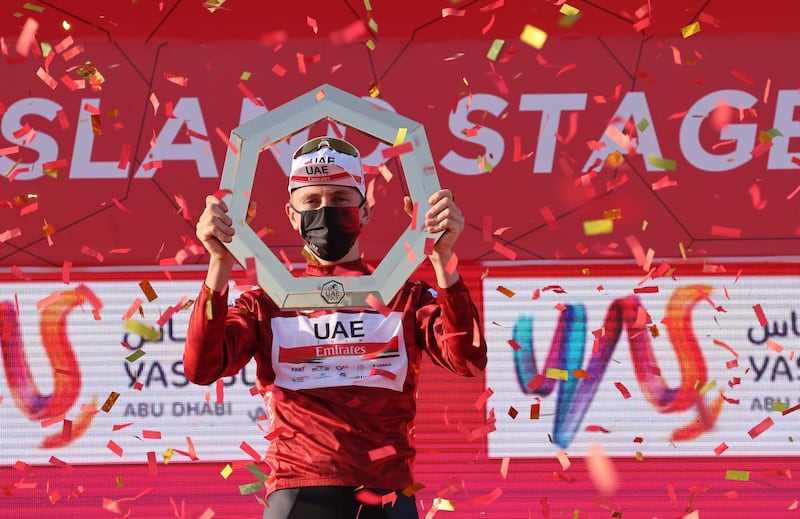 Tadej Pogacar of UAE Team Emirates celebrates on the podium after winning the 2021 UAE Tour. AFP
