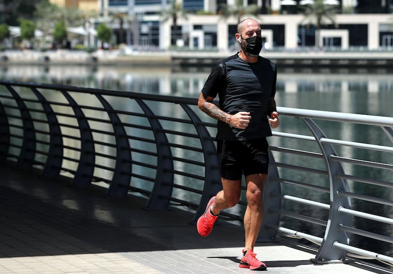Dubai, United Arab Emirates - Reporter: N/A: Coronavirus. A man exercises in the marina on the first morning where the government has eased restrictions on personal travel due to Covid-19. Friday, April 24th, 2020. Dubai. Chris Whiteoak / The National