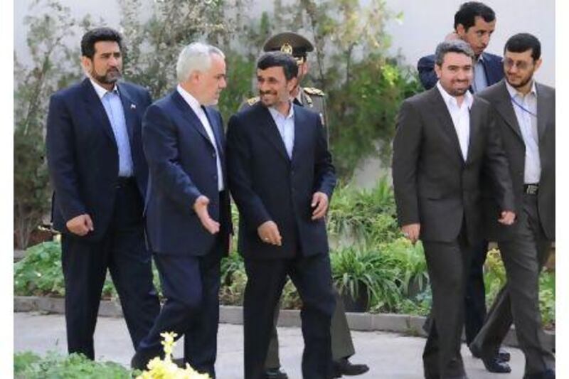 Their connection is plain to see as Mahmoud Ahmadinejad shares a word with Mohammad-Reza Rahimi, second from left, before the arrival of the Bolivian president in Tehran in October.