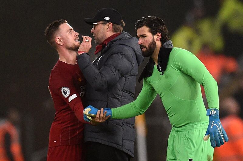 Liverpool's Jordan Henderson, left, manager Jurgen Klopp and goalkeeper Alisson Becker after the win over Wolverhampton Wanderers. AFP