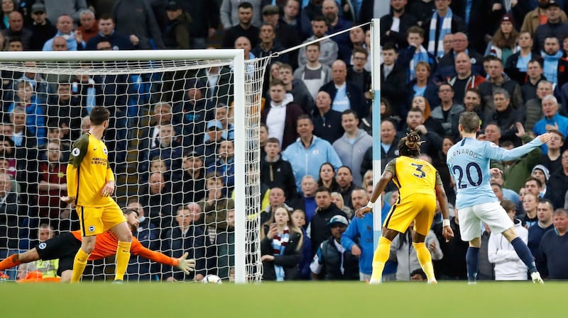 Manchester City's Bernado Silva, right, scores his side's second goal of the game against Brighton & Hove Albion during the English Premier League soccer match at the Etihad Stadium, Manchester, England, Wednesday May 9, 2018. (Martin Rickett/PA via AP)