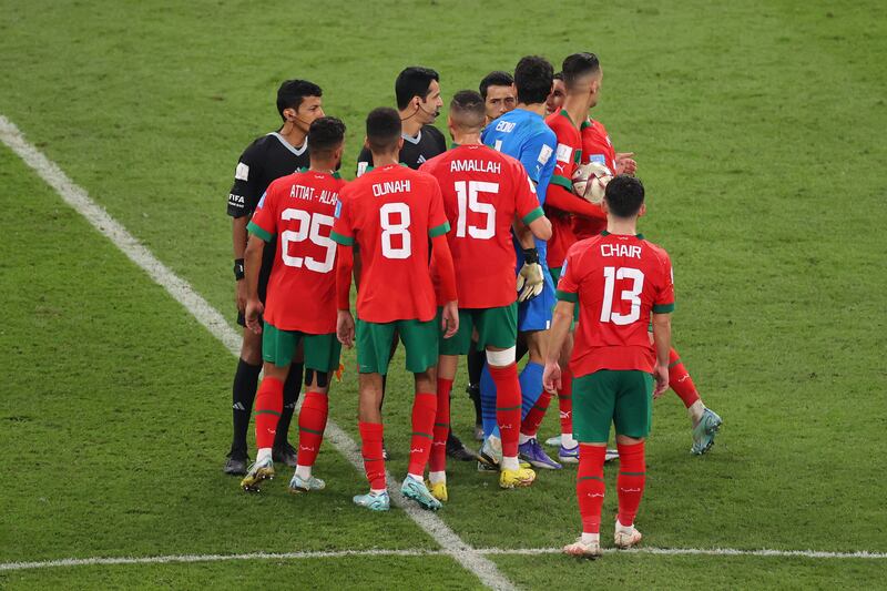 Morocco players argue with referee Abdulrahman Al Jassim and match officials after the defeat. Getty