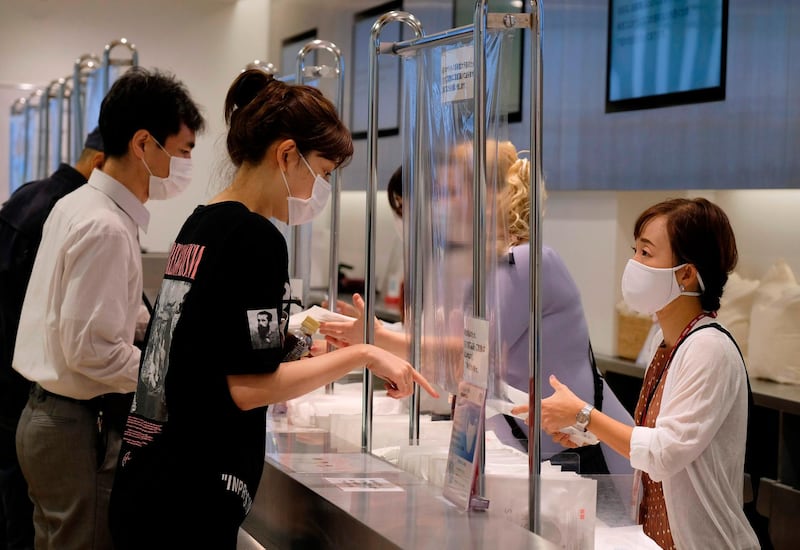 Customers purchase face masks made by Japan's Fast Retailing Co. at a Uniqlo store in Tokyo's Ginza shopping district in Japan. AFP