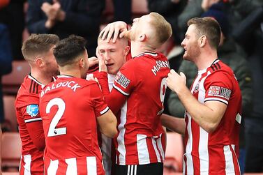 Sheffield United's John Lundstram, centre, is mobbed by teammates after his winning goal against Bournemouth. PA 