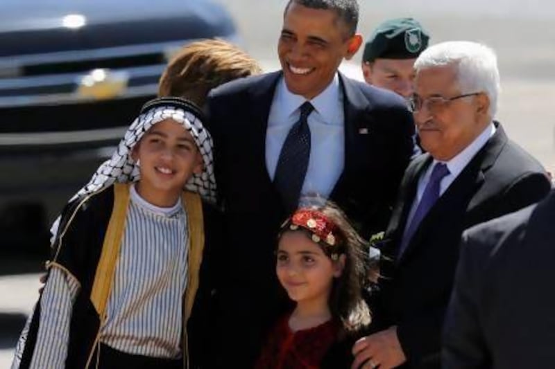 US president Barack Obama and Palestinian president Mahmoud Abbas pose for a photo with Palestinian children during a welcoming ceremony in the West Bank city of Ramallah.