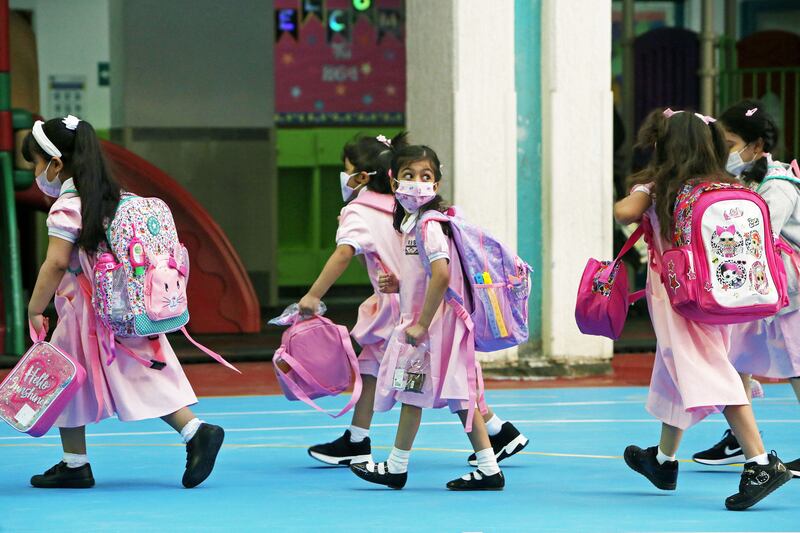Children get ready to go back to in-person classes in Kuwait City.