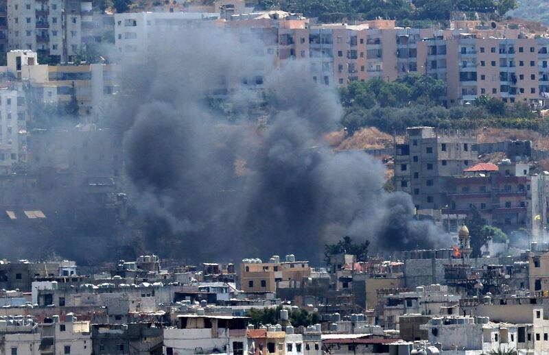 Smoke rises from buildings in Ain el-Helweh, Lebanon's largest Palestinian refugee camp, near the southern coastal city of Sidon, during ongoing clashes between Palestinian security forces and Islamist fighters on August 21, 2017.
The clashes first broke out on August 17 when gunmen from the small Islamist Badr group opened fire on a position of Palestinian security forces inside the camp, a Palestinian source said. / AFP PHOTO / Mahmoud ZAYYAT