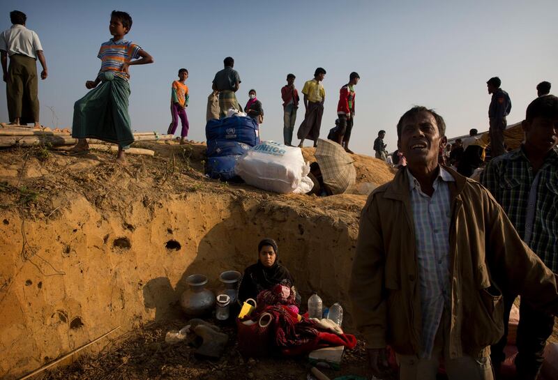 A Rohingya refugee Muslim who was staying in no-man's land at Bandarban between Myanmar and Bangladesh border, sits with her belongings after arriving at Balukhali refugee camp 50 kilometres (32 miles) from, Cox's Bazar, Bangladesh Wednesday, Jan. 24, 2018. Rohingya Muslims who fled persecution in Myanmar say some of them had returned home several times over past decades, and they're in no mood to repatriate again. Although, Myanmar says it's ready for a gradual repatriation of Muslim Rohingya refugees chased out by the Buddhist-majority country's military. More than 680,000 Rohingya Muslims are now living in sprawling and squalid refugee camps in Bangladesh. (AP Photo/Manish Swarup)