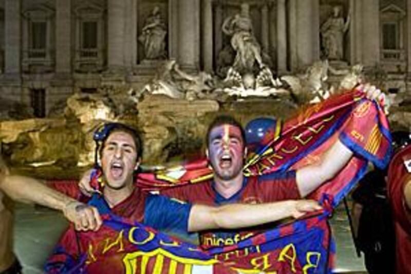 Barcelona fans celebrate at the Trevi fountain after their team's victory over Manchester United gave the club an unprecedented treble of domestic cup, league and European titles.