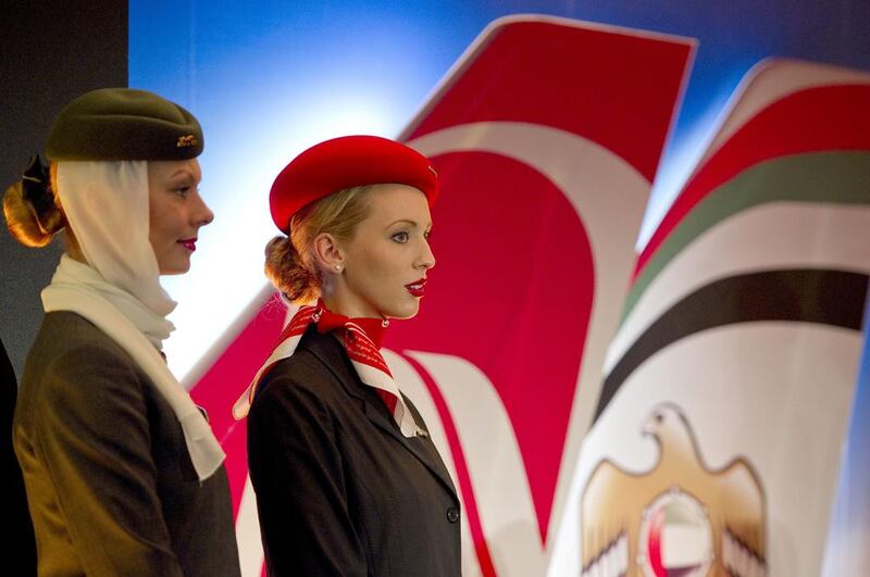 Air hostesses from Etihad Airways, left, and Air Berlin, right. Etihad said it would subscribe to a €300m convertible bond to support airberlin. Odd Andersen / AFP

