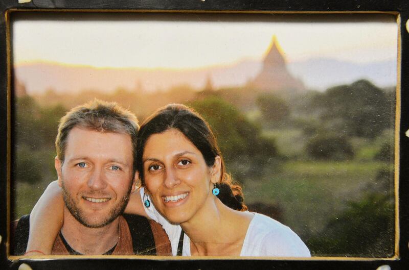 A photo of Richard Ratcliffe and his wife Nazanin Zaghari-Ratcliffe, who has been jailed in Iran, on display at their home in north London on Sunday Dec. 17, 2017.  British media on Thursday Dec. 21, 2017 were reporting that British-Iranian woman Nazanin Zaghari-Ratcliffe detained for months in Iran for allegedly plotting to overthrow the government could be released "within a couple of weeks." (John Stillwell/PA  via AP)