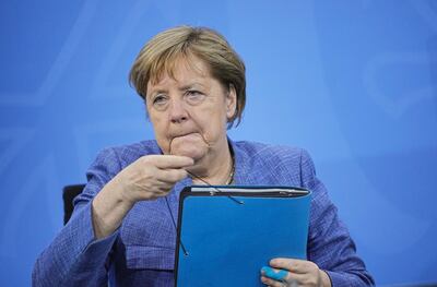 German Chancellor Angela Merkel takes her documents after a news conference following a meeting with the leaders of the country's 16 federal states to discuss COVID-19 measurements in Berlin, Germany, June 10, 2021.   Michael Kappeler/Pool via REUTERS