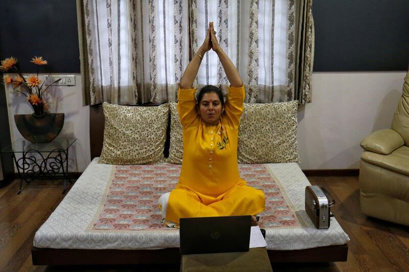 A woman conducts a virtual yoga session from her house in Ahmedabad, India. Reuters