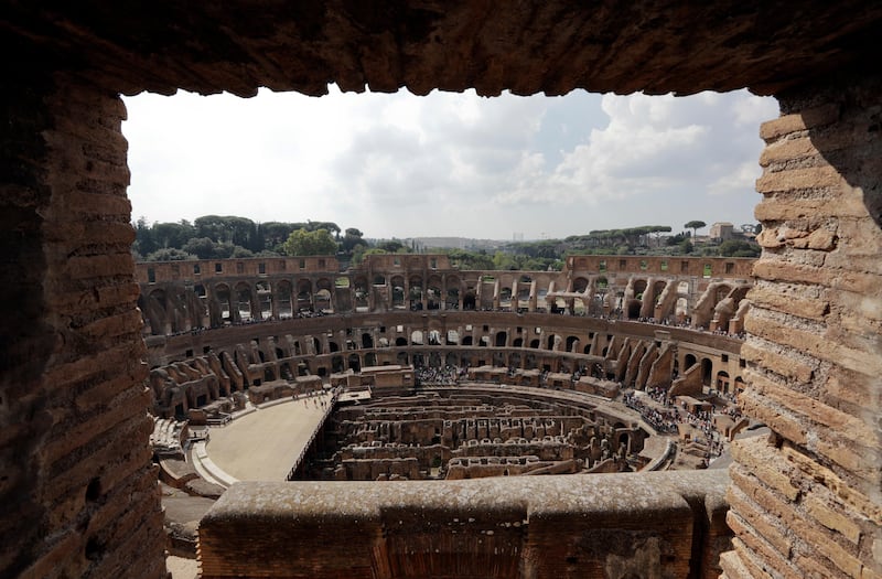 Tourists are seen visiting the ancient Colosseum as seen from a window on the occasion of a media tour presenting the re-opening after forty years of the fourth and fifth level of the Italy's most famous site, in Rome, on Tuesday, October 3, 2017. Andrew Medichini / AP Photo
