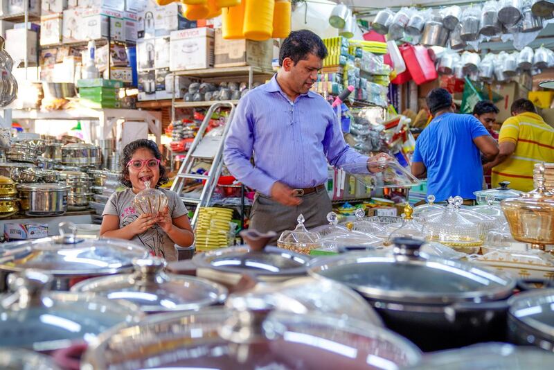 Abu Dhabi, United Arab Emirates, July 17, 2019.  Vendors of Al Mina Photo Project. --
Father and daughter shop for kitchenware at the Al Mina Souk.
Victor Besa/The National
Section:  NA
Reporter: