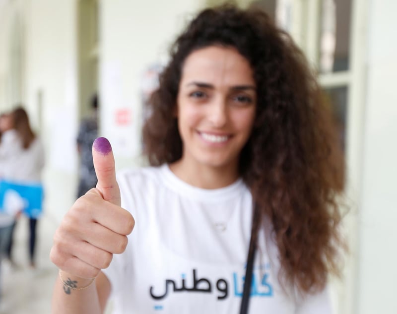 A woman shows her ink-stained finger after casting her vote during the parliamentary election in Beirut, Lebanon. Jamal Saidi / Reuters