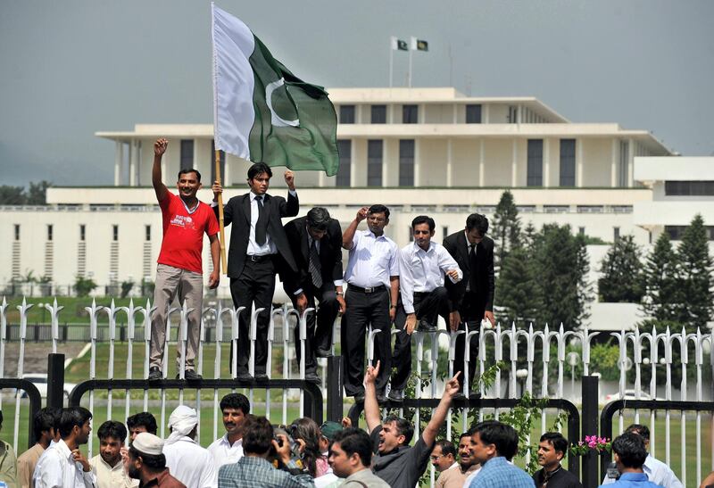 Pakistani lawyers celebrate after President Pervez Musharraf announced his resignation in front of the presidency in Islamabad on August 18, 2008.  Musharraf announced his resignation on August 18 in the face of looming impeachment charges, ending a turbulent nine years in power for the key US ally. The former army chief, who seized power in a bloodless coup in 1999, had been under huge pressure to quit before the coalition government launched the first impeachment proceedings in Pakistan's 61-year history.        AFP PHOTO/Farooq NAEEM (Photo by FAROOQ NAEEM / AFP)