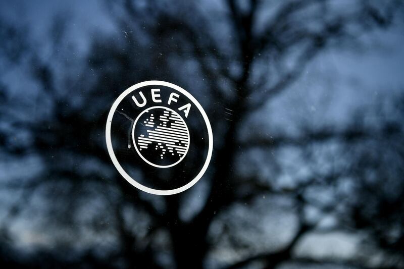 (FILES) In this file photo taken on February 28, 2020 shows the UEFA logo at the organization's headquarters in Nyon. UEFA and Europe's top clubs have stated their determination that the current football season should be played to a conclusion and threatened that teams may be excluded from the next Champions League if their domestic competitions are ended prematurely. In a joint letter released late on April  3, 2020, UEFA, the European Club Association (ECA), and the European Leagues body representing nearly a thousand clubs in 29 countries, said that they were working on the possibility of playing on into July and August if need be. / AFP / Fabrice COFFRINI
