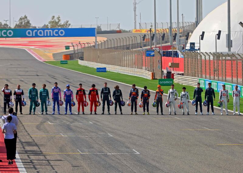 Drivers pose on the starting grid during the first day of Formula One pre-season testing at the Bahrain International Circuit. AFP