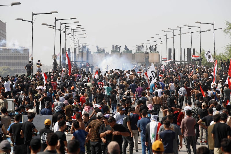 Tear gas rises as demonstrators gather in Tahrir Square in the centre of Baghdad.  AFP