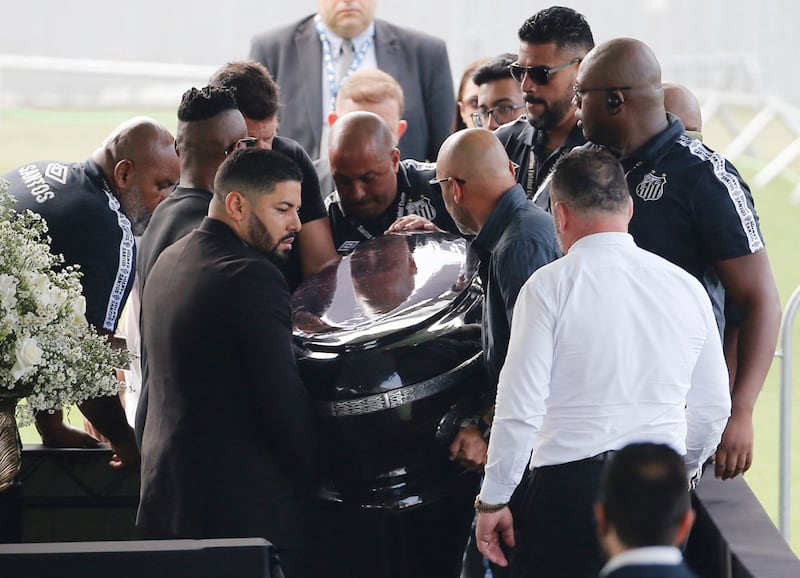 Pallbearers carry the casket of Brazilian legend Pele at Santos' stadium, where he will lie in state for 24 hours before his funeral. Reuters