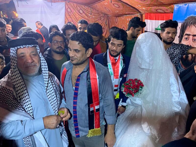 Relatives celebrate the marriage of Saif Ali, a protester who decided to celebrate marriage in Tahrir Square during ongoing anti-government protests. AP