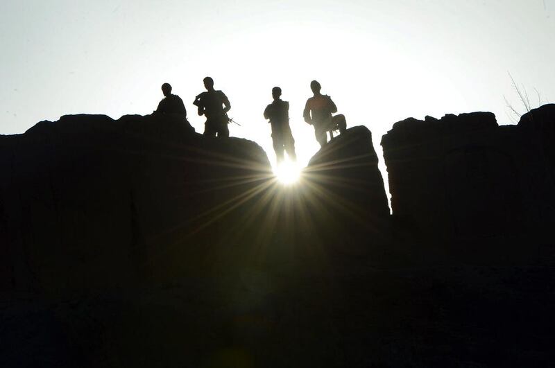 Afghan security personnel stand guard in Chaghcharan, the capital of central Ghor province. Wakil Kohsar / AFP