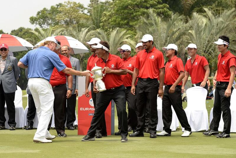 Team Europe captain Miguel Angel Jimenez, left, and Thongchai Jaidee, the Team Asia captain, pictured with the EurAsia Trophy during the singles format at the EurAsia Cup in Glenamarie Golf and Country Club in Kuala Lumpur. The four million USD biennial tournament is styled on the popular Ryder Cup, and organisers to the Asian Tour and European Tour hope it will spark a similarly exciting intercontinental rivalry. AFP PHOTO / Paul Lakatos