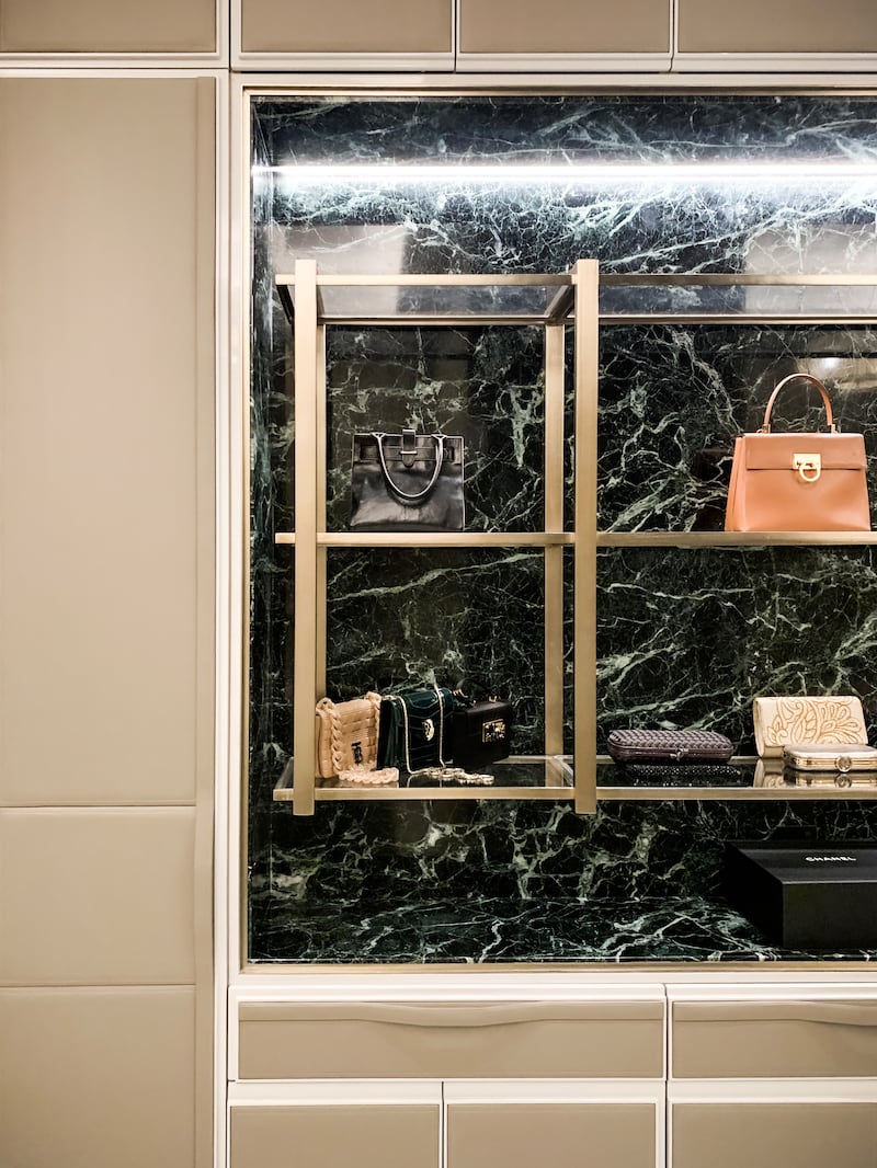 A vanity cabinet benefits from marble as its backdrop