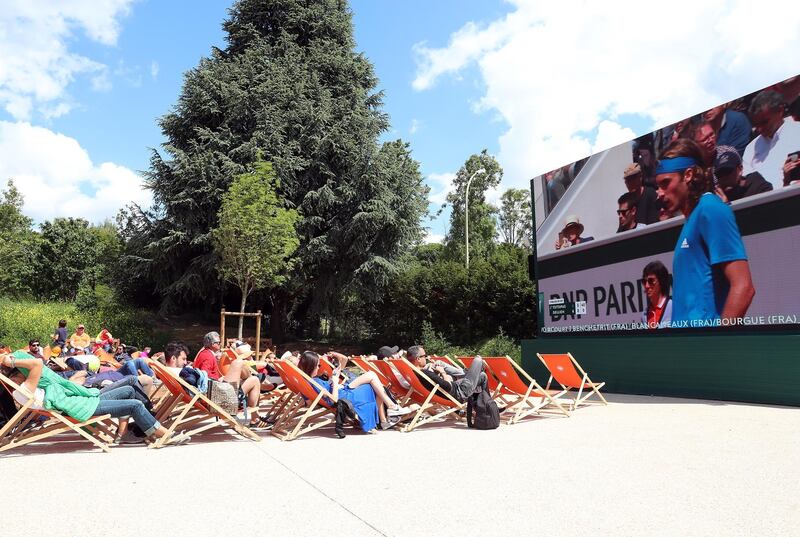 Spectators watch Stefanos Tsitsipas on a big screen during the 2019 French Open. EPA