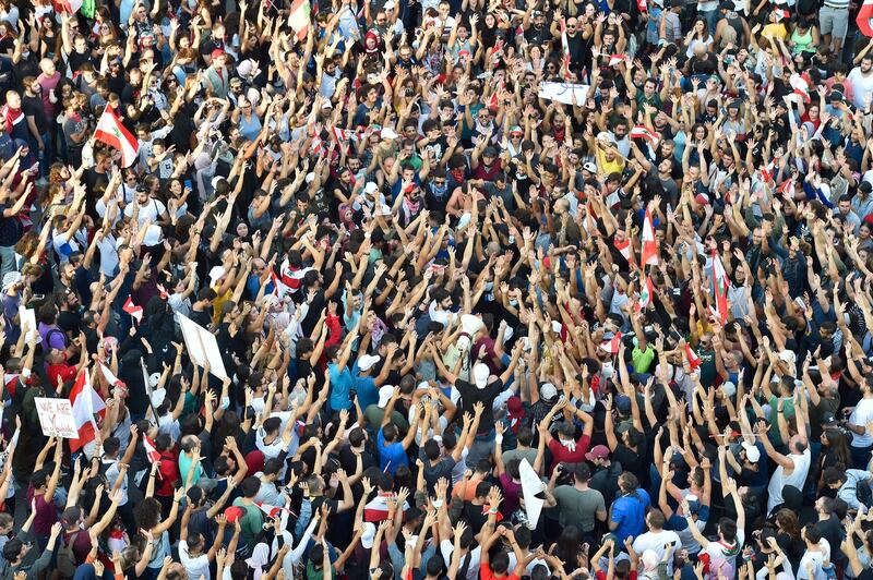 Protesters carry  flags during a protest in downtown Beirut. EPA