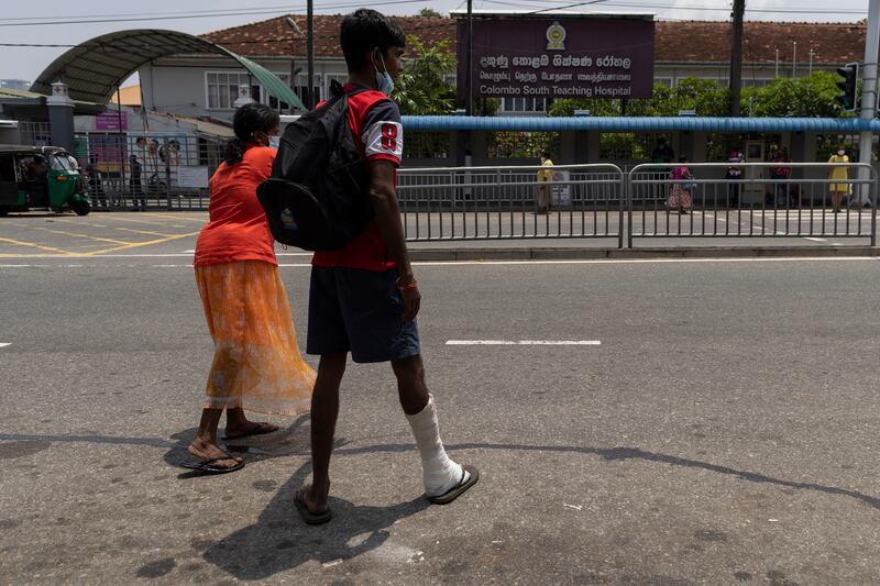 A patient stands with his mother outside Colombo South Teaching Hospital in Colombo. Getty Images
