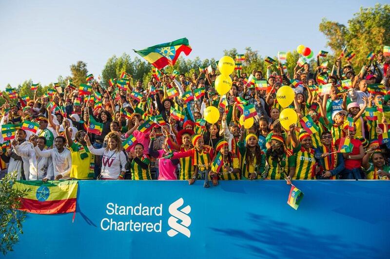 Ethiopian fans celebrate as two of their own, Aselefech Mergia in the women's field and Lemi Berhanu Hayle in the men's field, win the Dubai Marathon on Friday. Stephen Hindley / AP