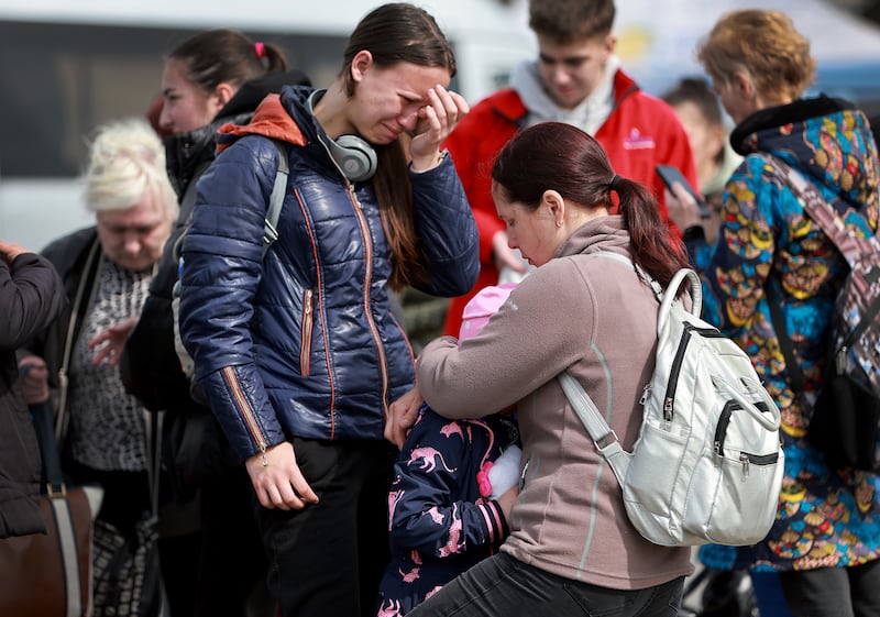 People fleeing Lviv, eastern Ukraine, in April 2022, wait for a bus that will take them to Poland. Getty Images