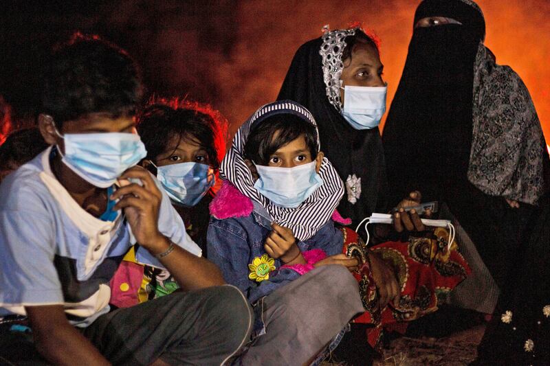 Families sit by a fire on a beach on Idaman Island in East Aceh, Indonesia. Despite the risks of crossing the Andaman Sea, the prospect of life in Malaysia and Indonesia attracts thousands. AP