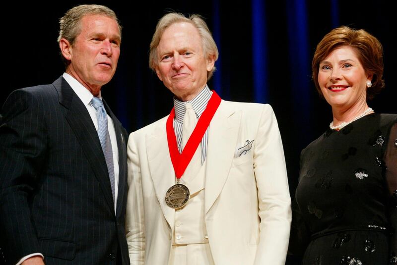 In this April 22, 2002 file photo, President Bush, left, poses with author Tom Wolfe, center, and first lady Laura Bush during the National Endowment for the Arts National Medal Awards ceremony at Constitution Hall in Washington . Wolfe was a recipient of the National Humanities Medal. Wolfe died at a New York City hospital. He was 87. AP
